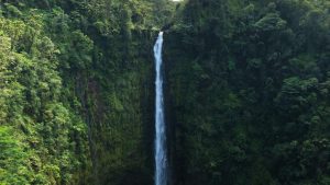 Beautiful waterfall in Big Island surrounded by green mountains