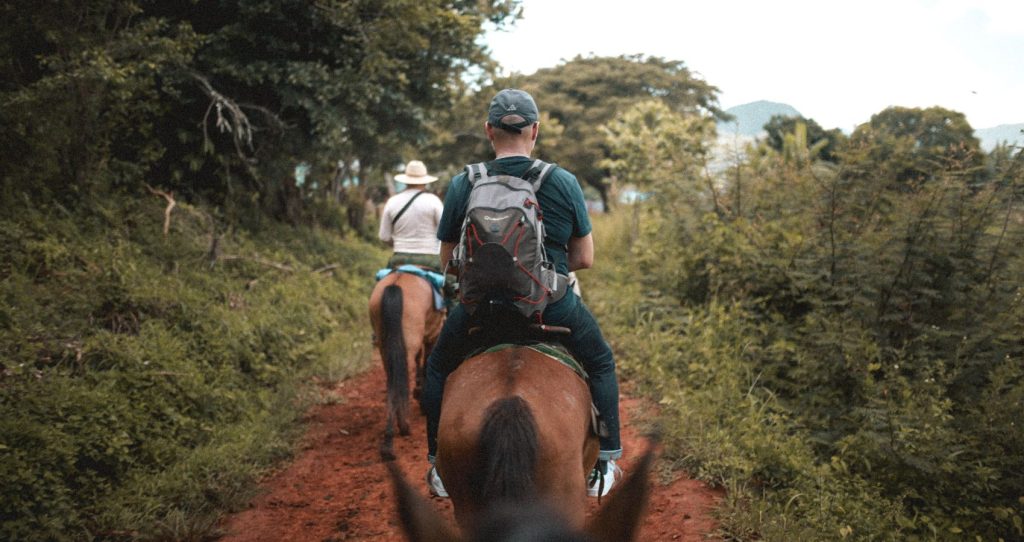 two tourists horseback riding in the Big Island, Hawaii during the Horseback Riding Tour