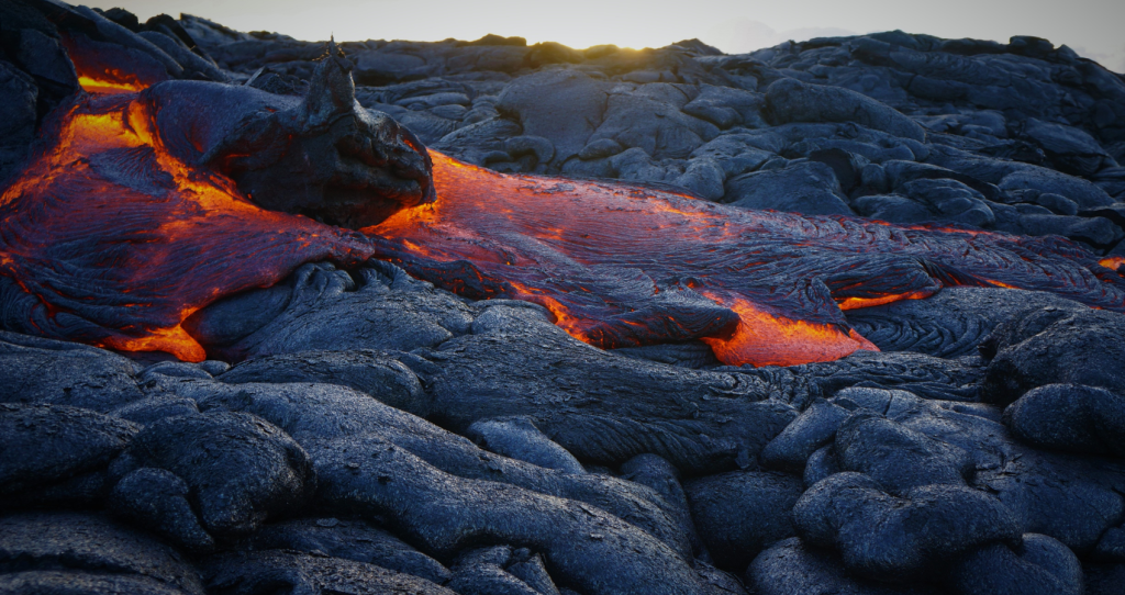 a stunning view of hot lava flow and black lava rocks at the Volcanoes National Park on the Big Island of Hawaii