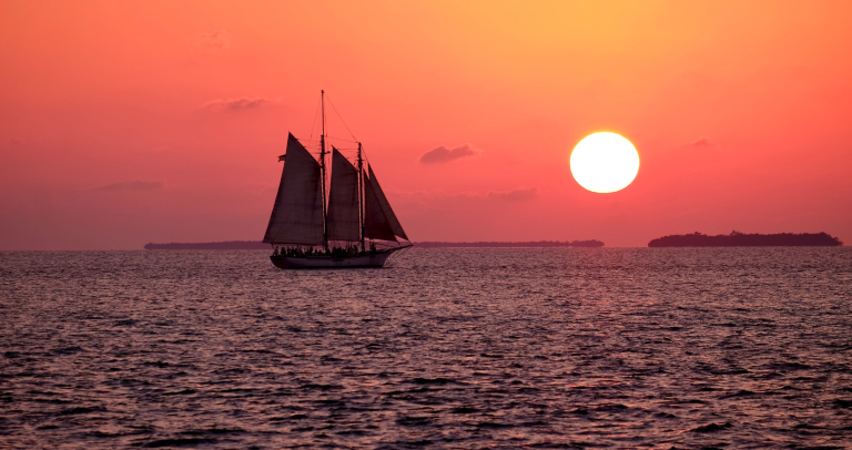 sailboat in Kailua-Kona with a sunset view