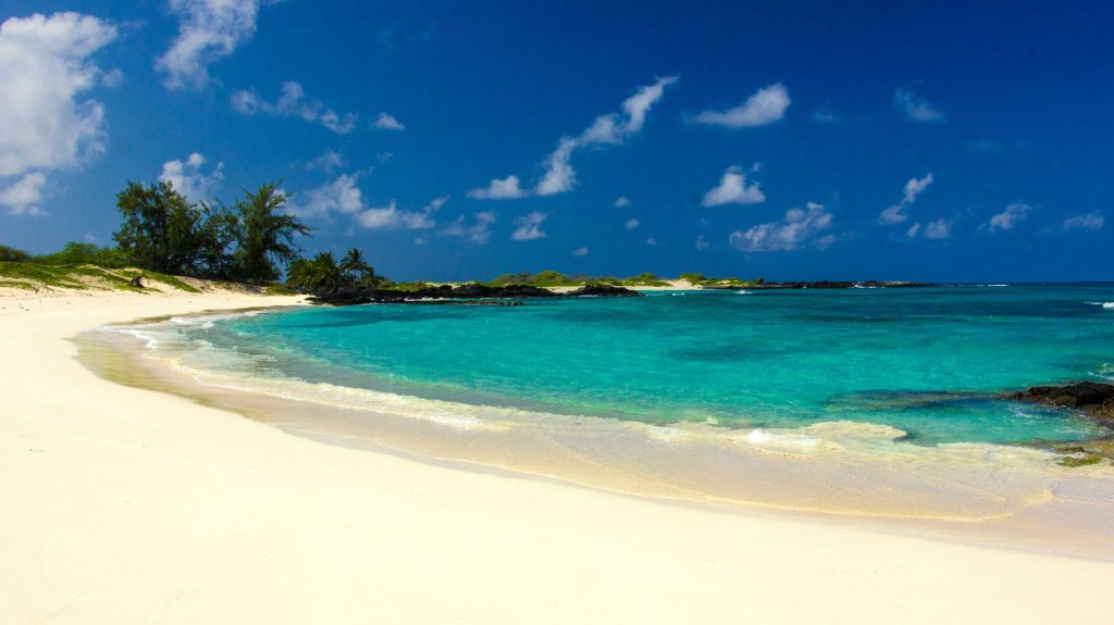 Makalawena Beach with clear blue waters and white sand on a sunny day