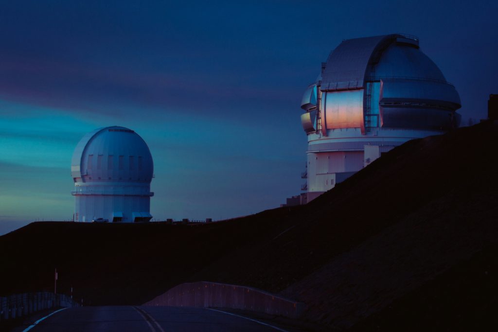 a white dome building atop a Mauna Kea mountain during daytime