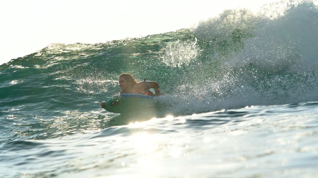 Big sea wave almost spilling over the surfer
