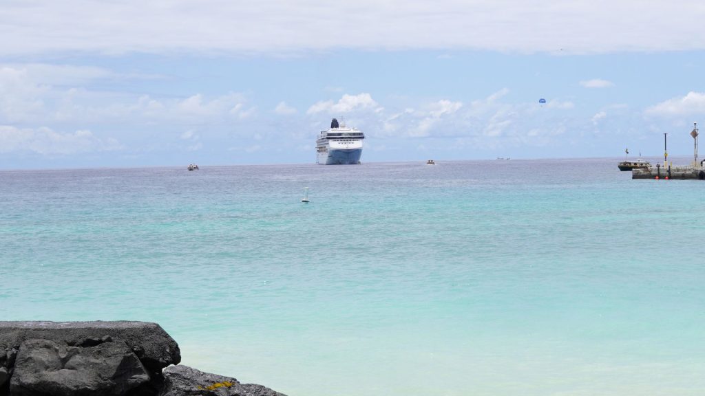 Cruise ship far away from the port of the island